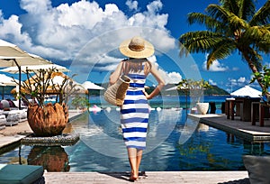 Woman sailor striped in dress near poolside