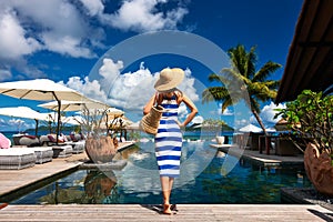 Woman sailor striped in dress near poolside