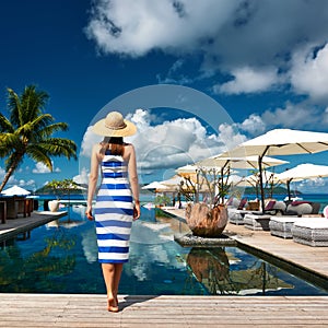 Woman sailor striped in dress near poolside