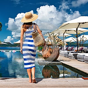 Woman sailor striped in dress near poolside