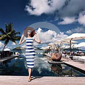 Woman sailor striped in dress near poolside