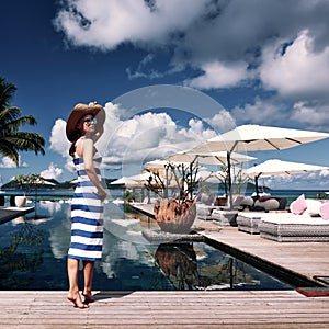 Woman sailor striped in dress near poolside