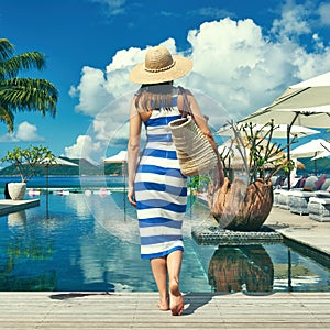 Woman sailor striped in dress near poolside