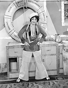 Woman in a sailors outfit in front of a life preserver photo