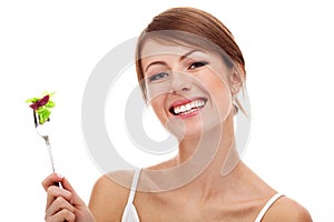 Woman with salad on fork, isolated photo