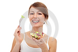 Woman with salad on fork, isolated photo
