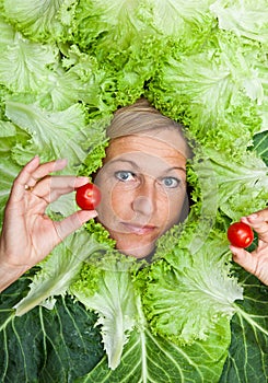 Woman with salal leafes around her head.