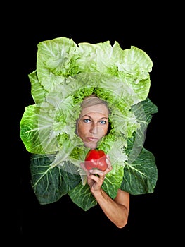 Woman with salal leafes around her head.