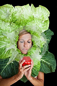 Woman with salal leafes around her head.