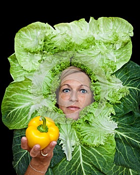 Woman with salal leafes around her head.