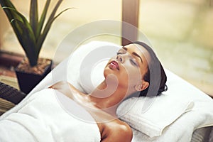 Woman, salon and sleeping on bed for wellness in Thailand, relax and pamper for muscles. Female person, beauty or photo