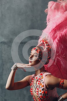 Woman in samba or lambada costume with pink feathers plumage