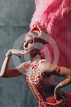 Woman in samba or lambada costume with pink feathers plumage