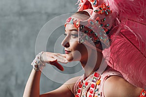 Woman in samba or lambada costume with pink feathers plumage