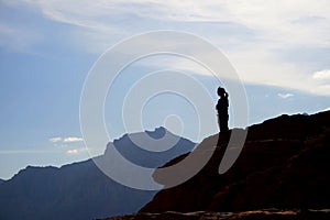 Woman on sandstone cliff