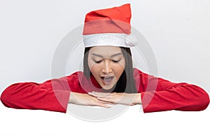 Woman with Santa Claus Hat Looking to Blank Copy Space For Advertisement