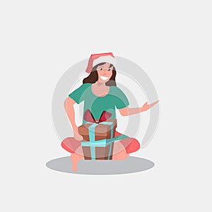 Woman in santa claus hat sitting with gift present box merry christmas happy new year winter holidays celebration
