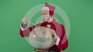 Woman Santa Claus Mesuring The Globe