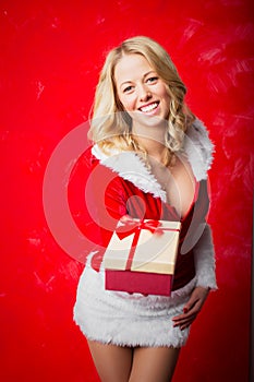 Woman in Santa costume giving present