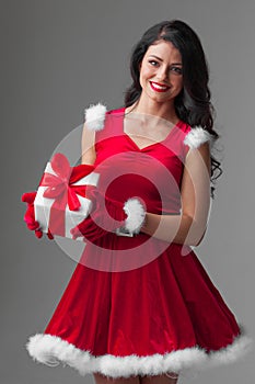 Woman in santa dress with gift