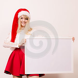 Woman in santa hat with blank banner. Copy space.