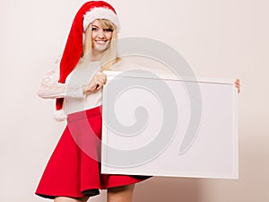 Woman in santa hat with blank banner. Copy space.