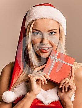 Woman in santa hat holding gift