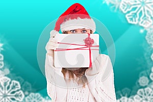 Woman in santa hat holding a gift box