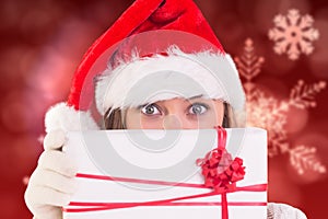 Woman in santa hat holding gift box