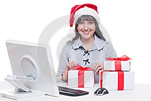 Woman in santa hat making christmas gifts