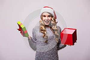 Woman in Santa hat open Christmas gift