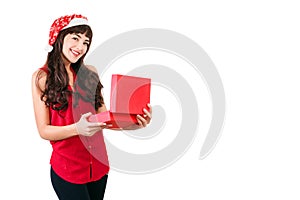 Woman in santa hat opening Christmas gift box isolated on white with copyspace. Happy girl unpacking her present