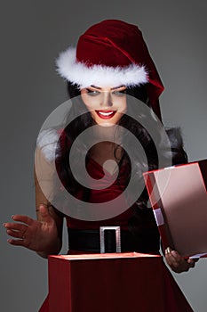 Woman in santa hat opening gift box