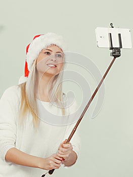 Woman in santa hat taking selfie