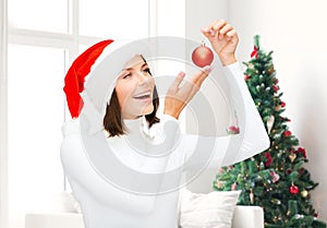 Woman in santa helper hat with christmas ball