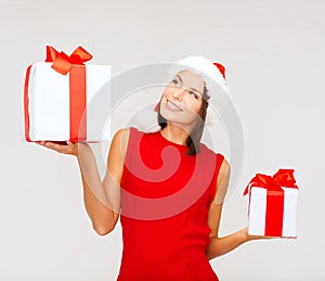 Woman in santa helper hat with many gift boxes