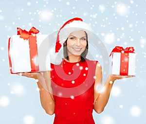 Woman in santa helper hat with many gift boxes