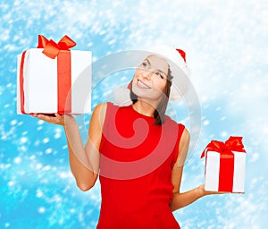 Woman in santa helper hat with many gift boxes