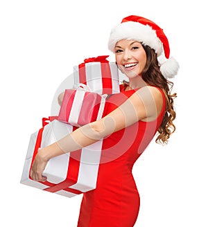 Woman in santa helper hat with many gift boxes