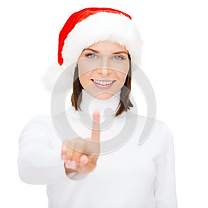 Woman in santa helper hat pressing vitrual button