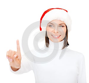 Woman in santa helper hat pressing vitrual button