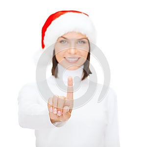 Woman in santa helper hat pressing vitrual button