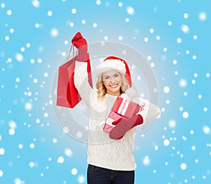 Woman in santa helper hat with shopping bags