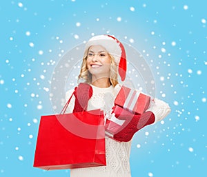 Woman in santa helper hat with shopping bags