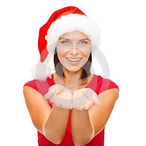 Woman in santa helper hat with something on palms