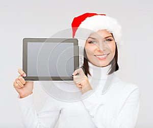 Woman in santa helper hat with tablet pc