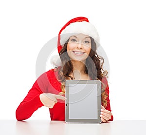 Woman in santa helper hat with tablet pc