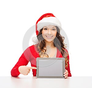 Woman in santa helper hat with tablet pc