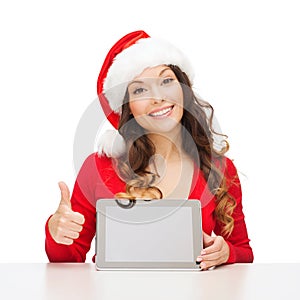 Woman in santa helper hat with tablet pc