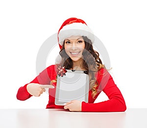 Woman in santa helper hat with tablet pc